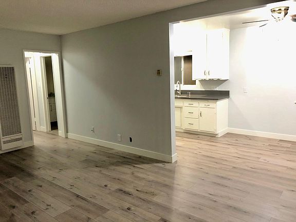 Very large living room which opens into dining room and kitchen. Wall is repaired now.