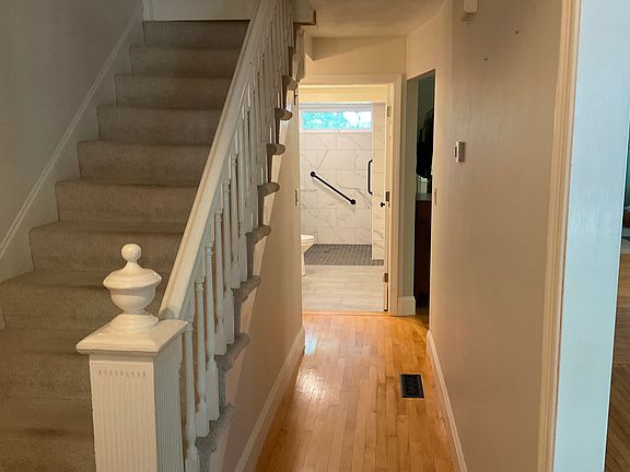 Front hallway. Stairs lead to a bolted door separating the rental unit from the owner''s private living space.