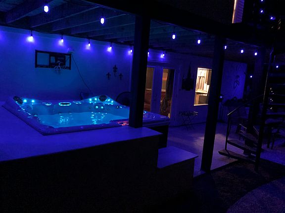 Covered back patio with a hot tub.