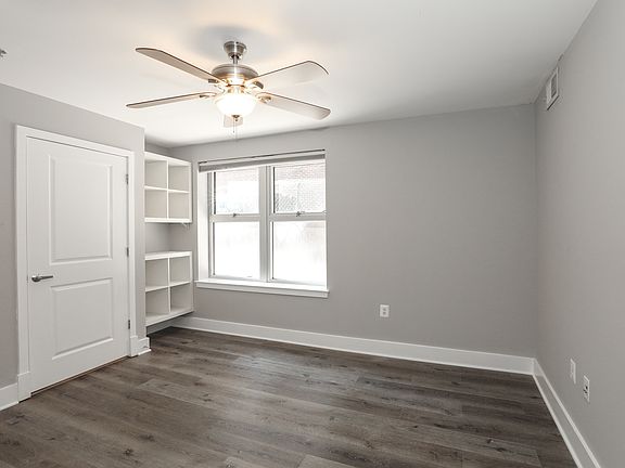 Comfortable Bedroom with Oversized Window and Ceiling Fan