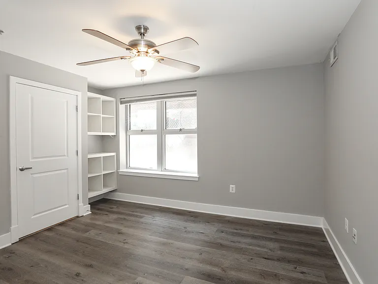 Comfortable Bedroom with Oversized Window and Ceiling Fan