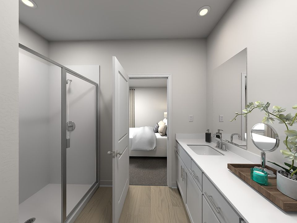 The primary bathroom offers dual vanity sinks and a walk-in shower.