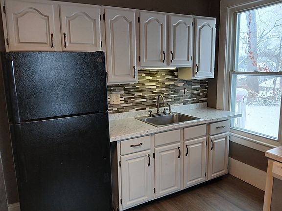 Freshly painted, ample cabinet space, new luxury vinyl flooring, stylish glass and stone backsplash, new countertop