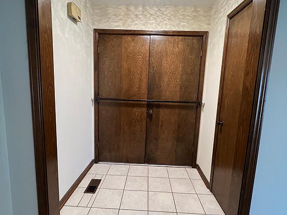 Entrance hall, front doors, and coat closet