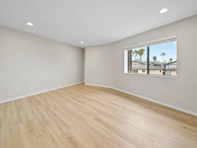 This huge bedroom has enough space for a king bed, an office, and a sitting room all in one place!