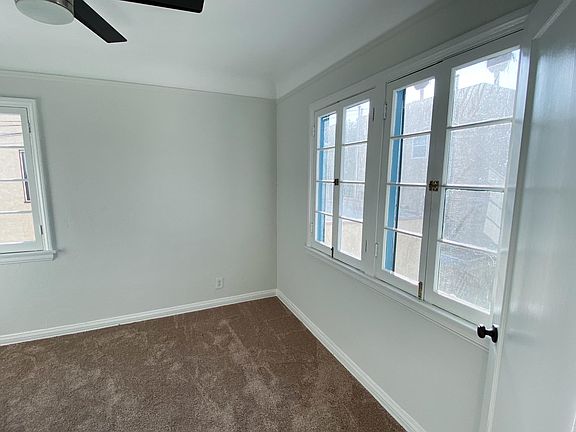 First bedroom off of the living room with beautiful large windows