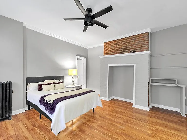 Bedroom, furnished with large chest, end tables, fireplace alcove for more storage, small build in desk, Led fan with control