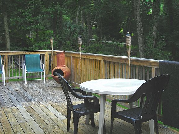 Deck overlooking park-like yard