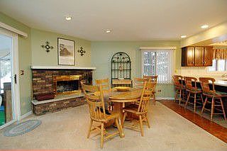 Eating area with cozy fireplace. Sliders to sun porch