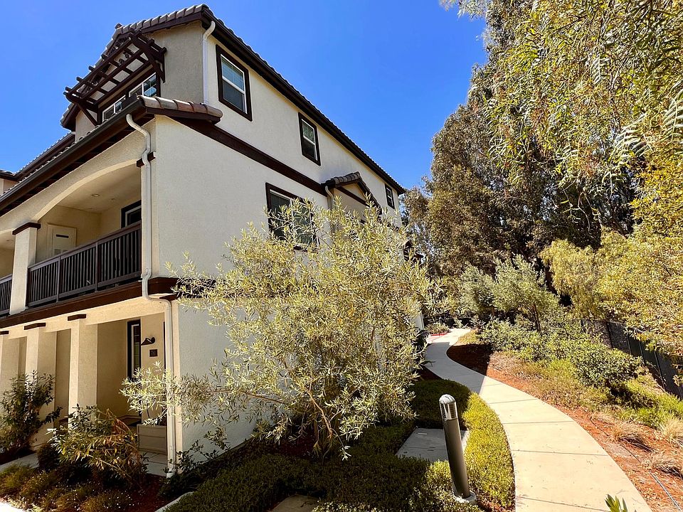 End unit featuring large side windows and private balcony overlooking a tree-lined creek.