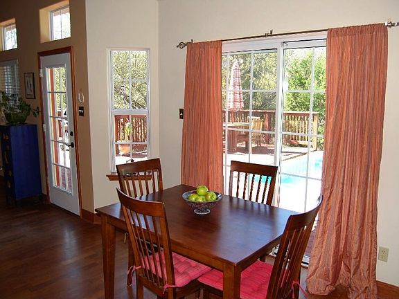 Dining area looks out at pool.