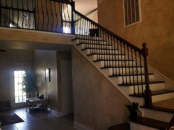 THE FRONT ENTRY BOASTS A BEAUTIFUL STAIRCASE