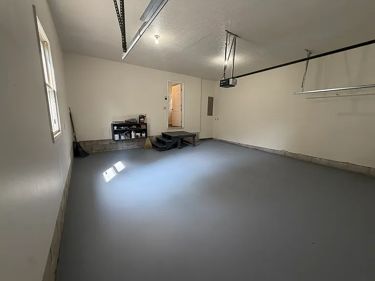 Clean and freshly painted garage with opener