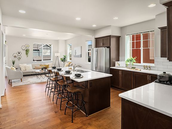 Featuring a new BOSCH dishwasher, stainless steel appliances, spacious quartz kitchen island, the kitchen serves as the heart of the home.