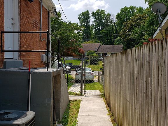 Fenced backyard. Walkway to to backyard basement entrance.