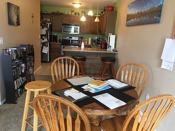 Kitchen is tiled floor with bar, Fridge, new oven, dishwashe
