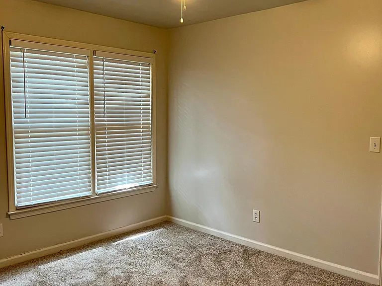 Third of three bedrooms with carpet and ceiling fan