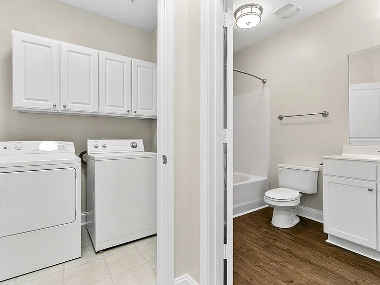 Laundry room and hall entry to 2nd bathroom with garden tub