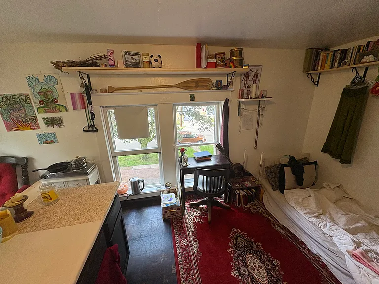 example room arrangement - with full windows bringing in much light to the sleeping area with desk