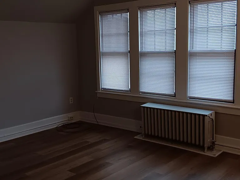 Living room windows providing lots of natural light and picturesque Street view.