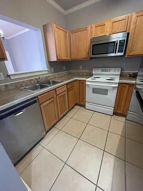 The white stove has been replaced with a stainless glasstop stove.