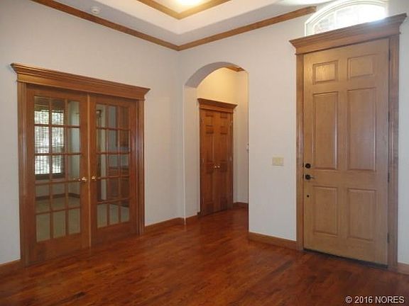 Interior view of front, coat closet and 4th bedroom/office French doors from entry hall.