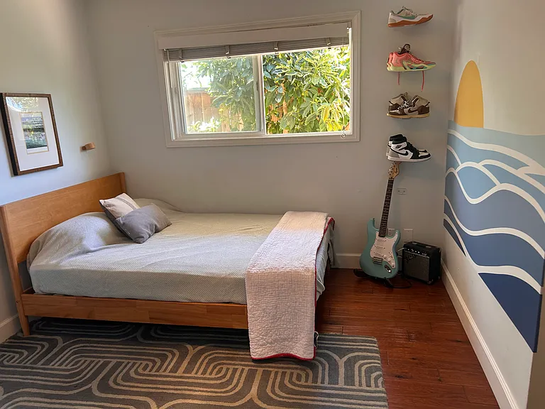 3rd bedroom with Double bed - looks out to the side yard / avocado trees.