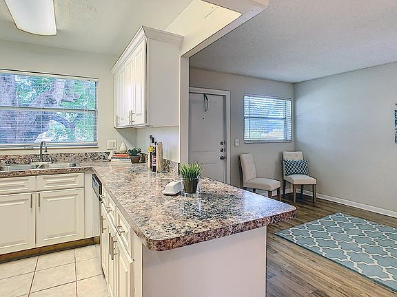 Kitchens feature a breakfast bar overlooking the living room area.