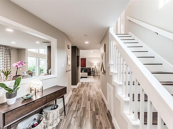 A view from the entry as you enter the home. The open floorplan entices you with views to your formal dining space on the left and the two story living room straight ahead.