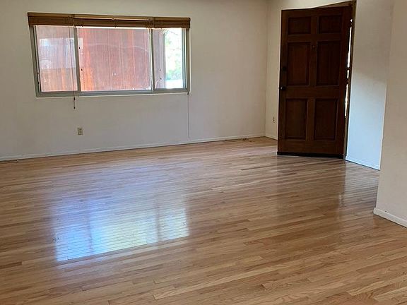 Living room with hardwood floors and natural light