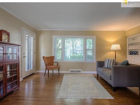 Living room has beautiful refinished hardwood floors, wonderful light and charming built-ins.