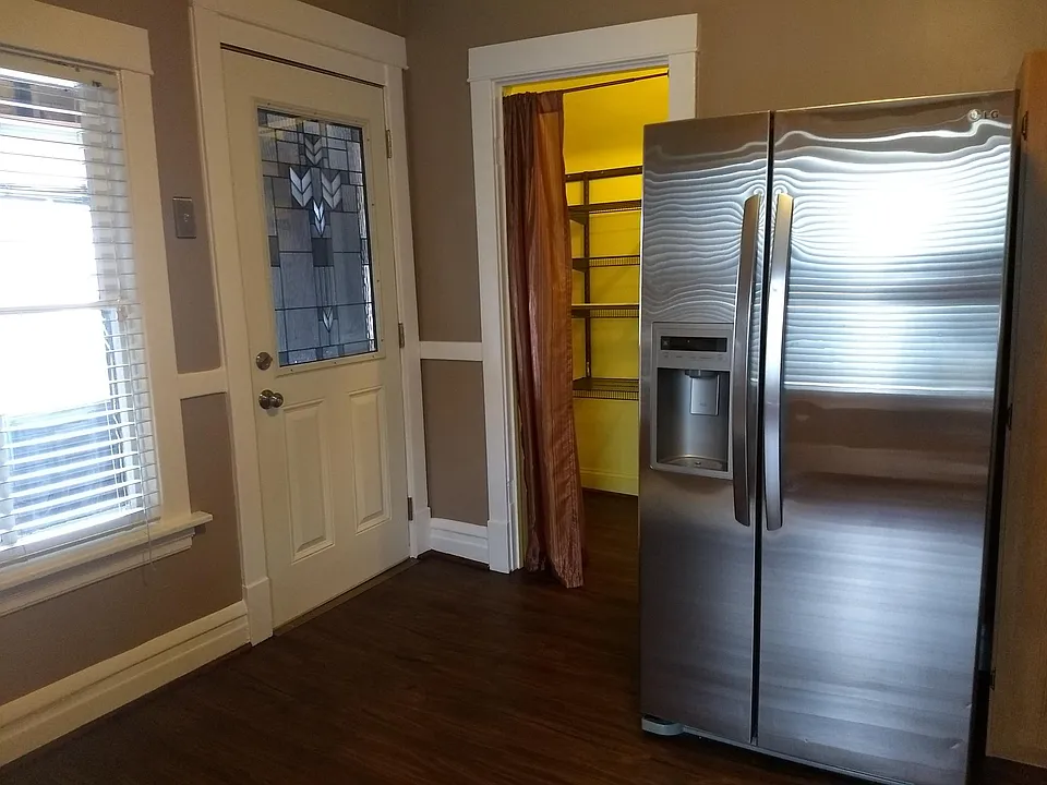Stainless steel fridge, Mission-style glass door, walk-in pantry.