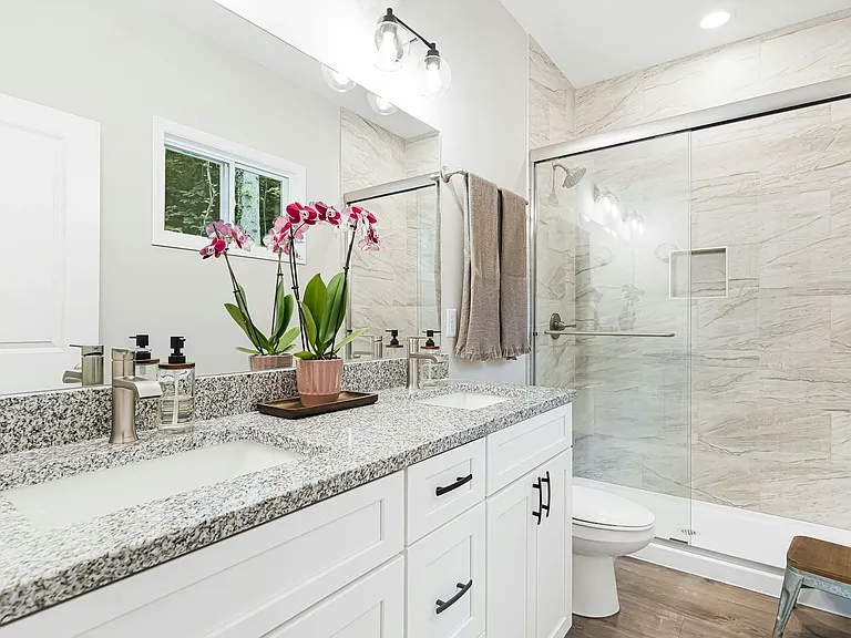 Primary bath, granite countertops and subway tiled bath
