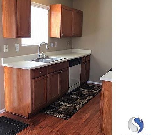 Kitchen w/ hardwood floors.
