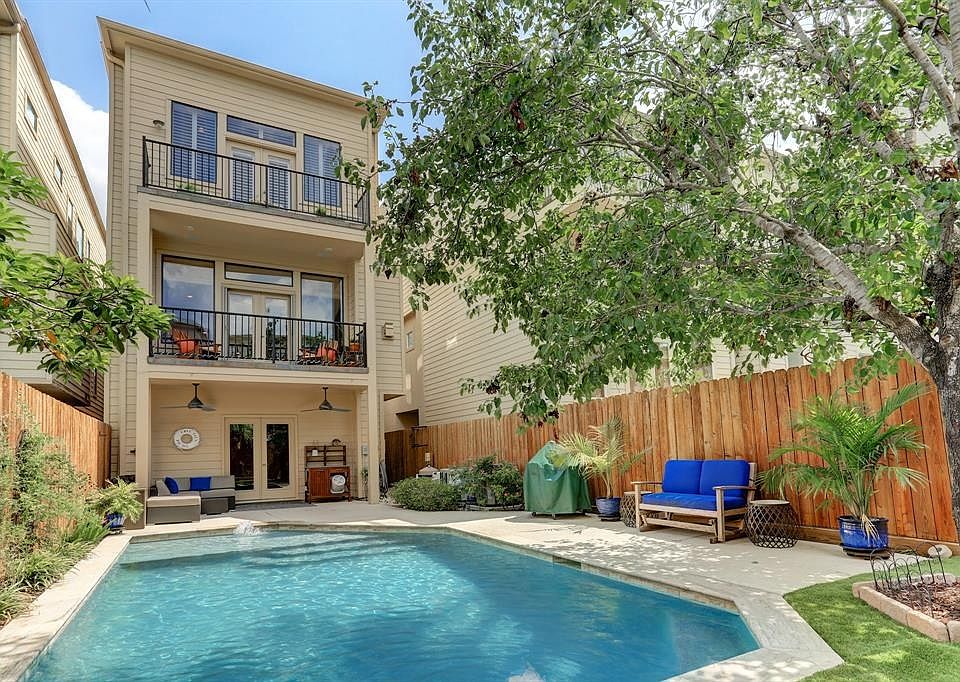 Beautiful spacious backyard, which features a recently renovated pool (2017), a covered patio, lush landscaping, and an artifici