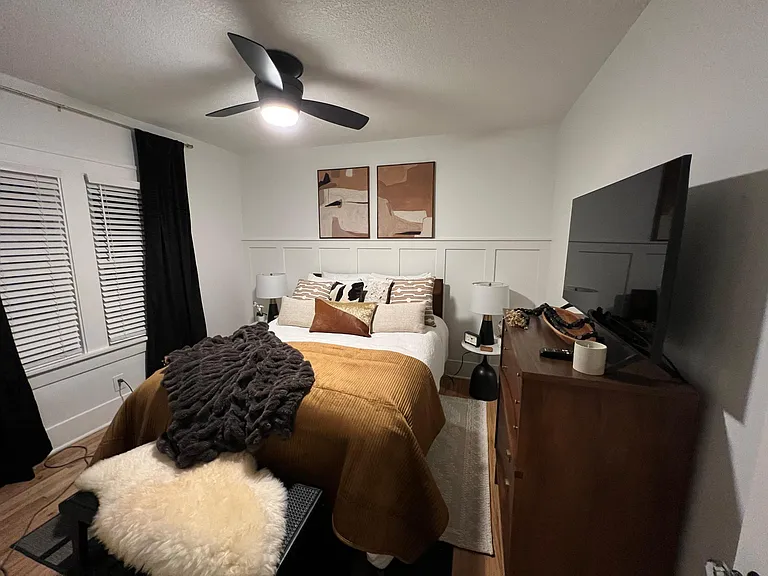 Queen sized bed, ceiling fan and TV