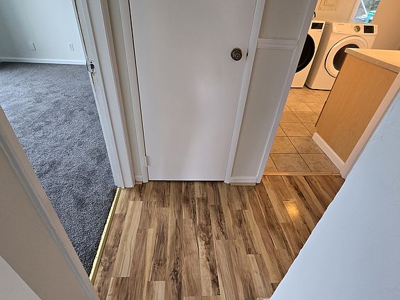 Hall. To the left is the main fron bedroom, in center is a hall closet, to right is laundry toom. Hard right is bathroom