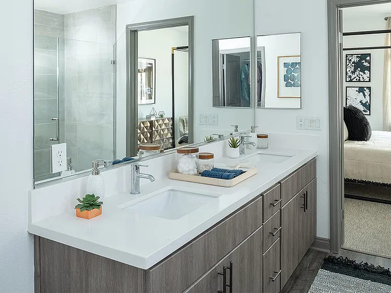 Apartment Bathroom with Double Sink and hardwood flooring.