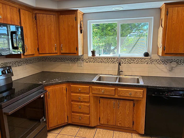 Kithen Sink window looks out to the back yard so you can enjoy watching your kids or dogs.