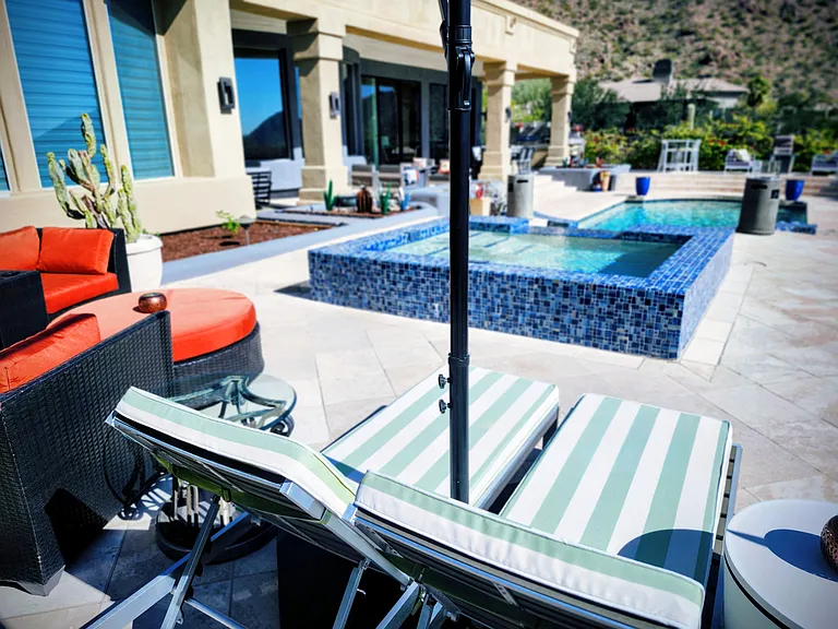 Lounge under a pool umbrella to the sounds of your waterfall while surrounded by mountains and bougainvillea.