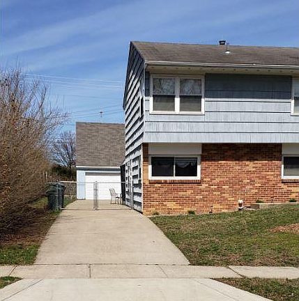Concrete driveway with gated access to backyard