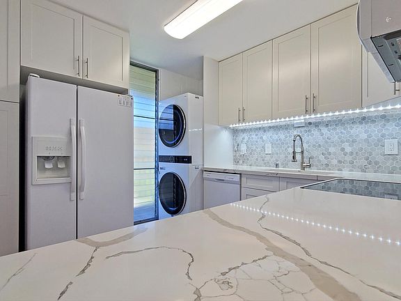 Newly remodeled open kitchen with quartz countertops, soft close cabinets, and luxury vinyl flooring