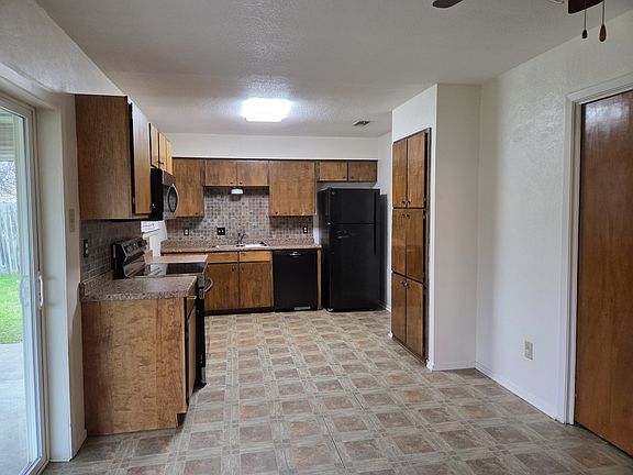 Kitchen with pantry and closet for washer /dryer connections.
