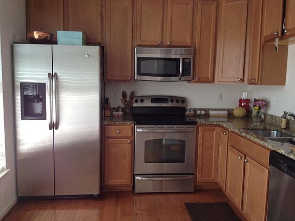 Modern kitchen with stainless steel appliances, granite coun