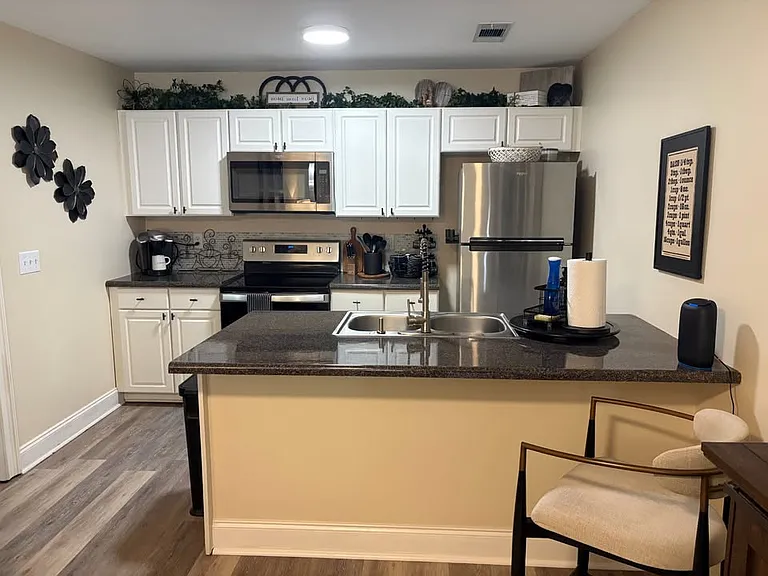 Full kitchen with all new appliances; microwave, full stove and oven, refrigerator/freezer with icemaker, sink disposal, full size dishwasher, coffee maker and all kitchen flatware, dishes, glasses and pots and pans included.