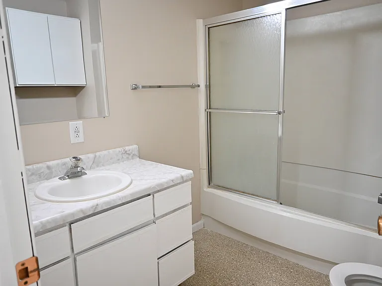 Bathroom with sliding glass shower doors.
