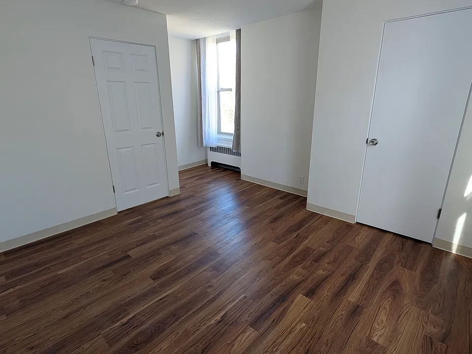 Bedroom facing door and closet