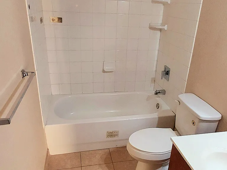 Full bathroom with extra storage closet