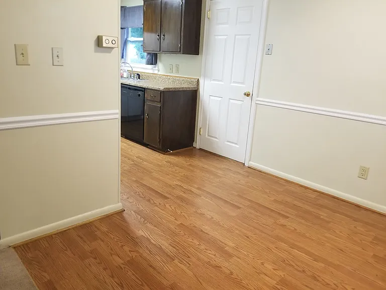 White door between dining room and kitchen is laundry room.