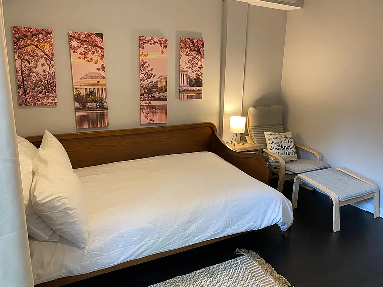 Bedroom #2 with a double sleigh bed, desk, lounge chair and sliding door to patio.